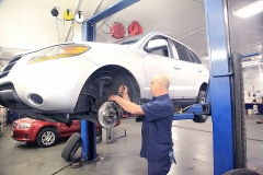 Mechanic working on a vehicle at Amtech Auto Care Inc. - image #8